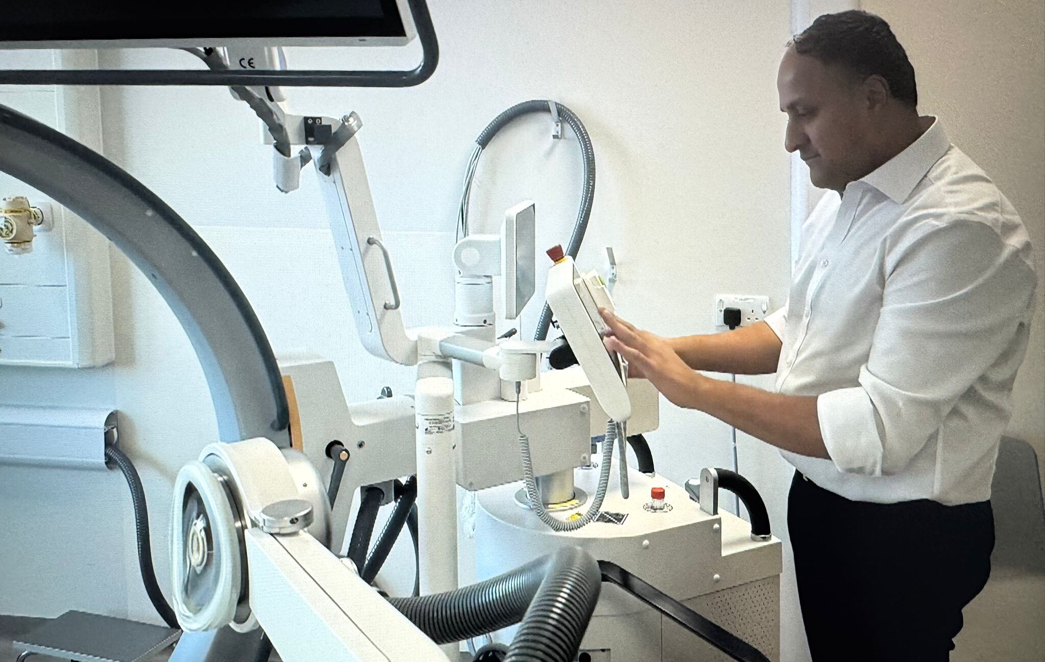 Consultant urologist Dr Fahd Khan using diagnostic equipment for prostate conditions in Birmingham